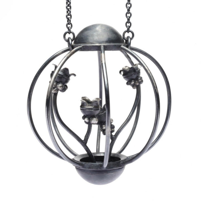 Pendentif cage inspiré par la nature en argent forgé patiné noir, 4 épis semblent pousser à l'intérieur.la chaîne mesure 70 cm